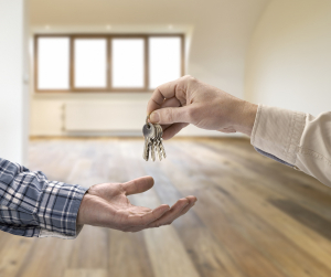 man handing keys over to a modern home