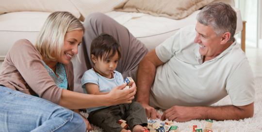 Son playing with his parents at home